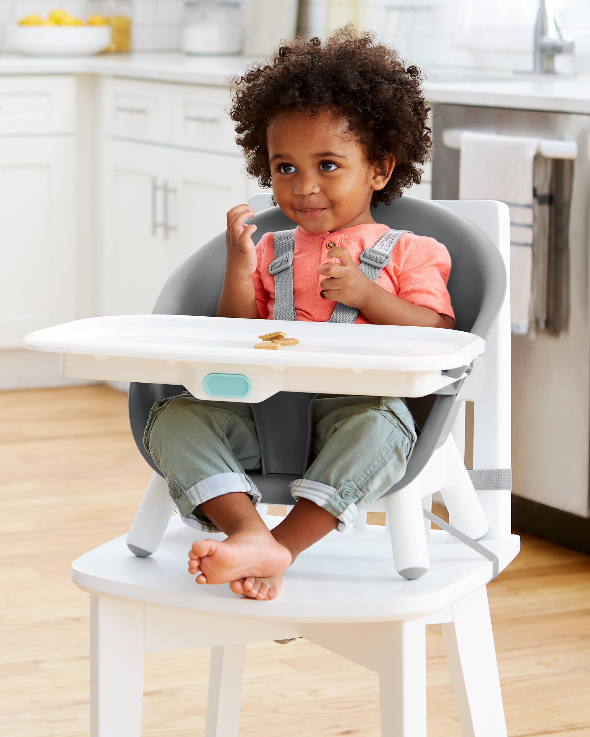 When does a baby sit in a high chair best sale